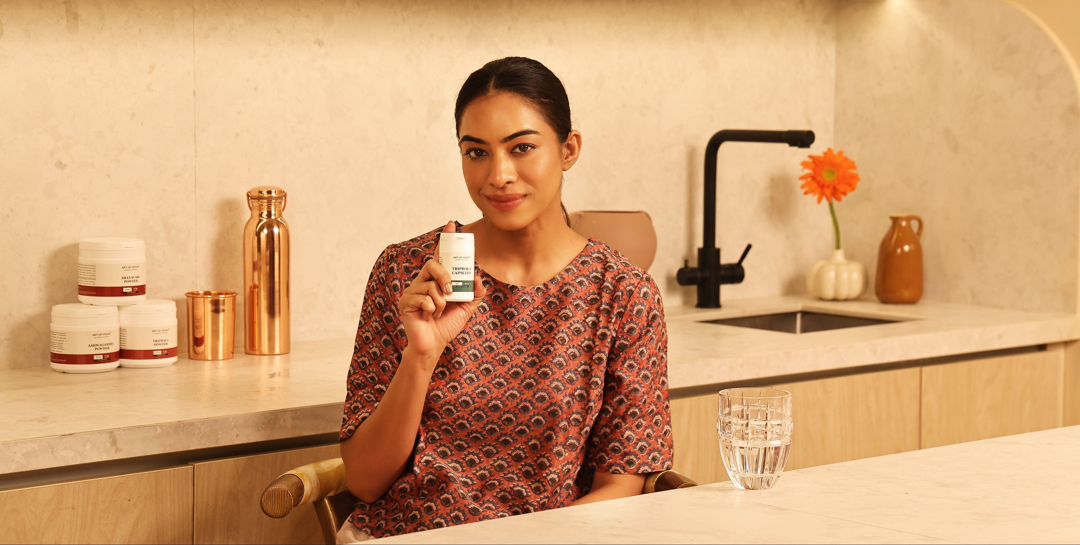 Art of Vedas Ayurveda Supplements - Woman Holding Ayurvedic Herbal Supplement Bottle for Natural Wellness and Health